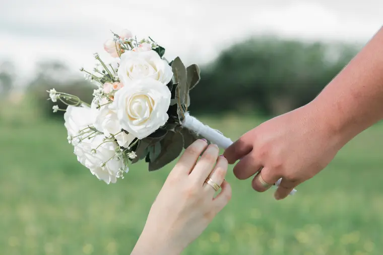 Person Handing a Bouquet